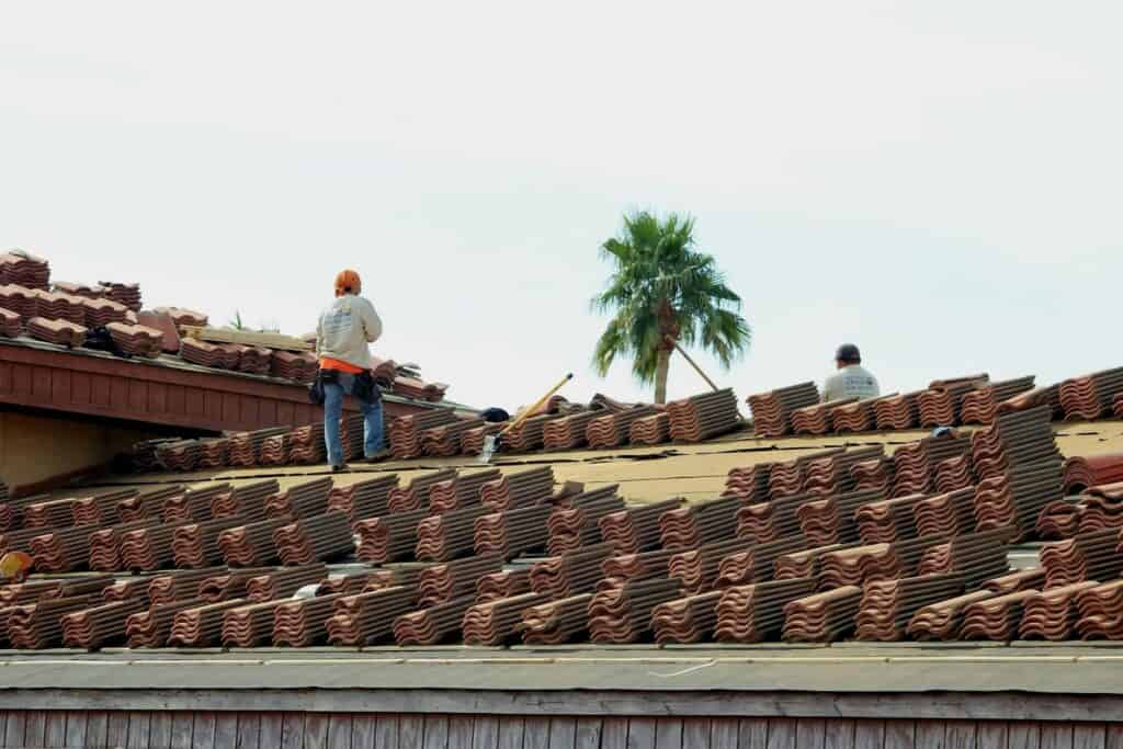 Roofing crew working on a tile roof
