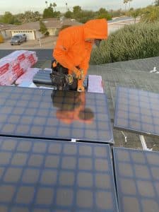 SolarFIX technician removing solar panels from a roof